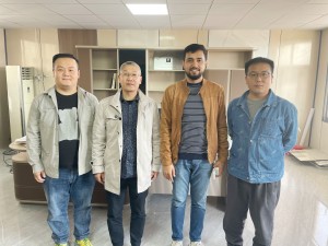 Group photo at the factory inspection site.